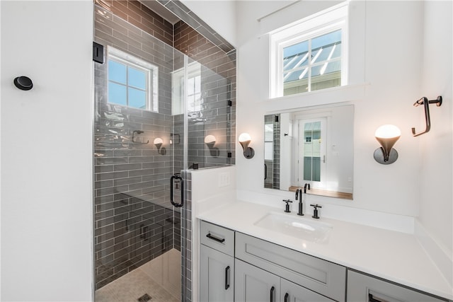 bathroom featuring vanity and a shower with door