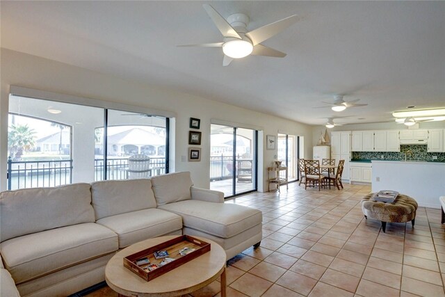 tiled living room featuring ceiling fan