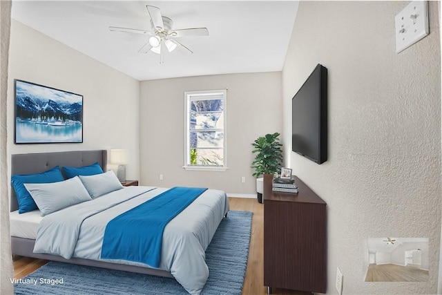 bedroom with ceiling fan and hardwood / wood-style flooring