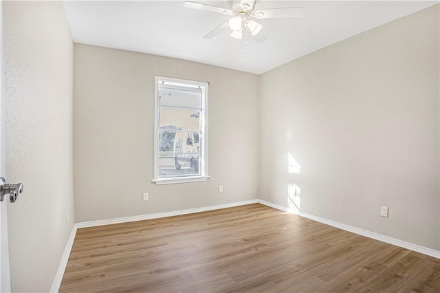 empty room with ceiling fan and hardwood / wood-style flooring