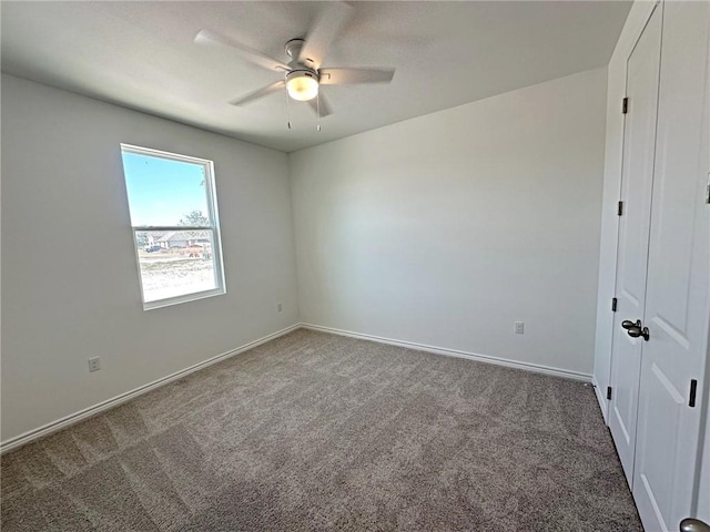 unfurnished room featuring carpet flooring and ceiling fan