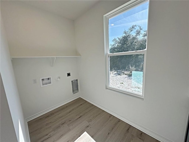 clothes washing area with washer hookup, light hardwood / wood-style floors, gas dryer hookup, and electric dryer hookup