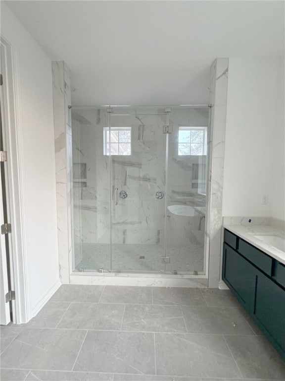 bathroom featuring vanity and an enclosed shower