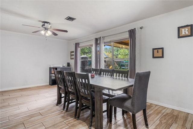 10637 Westwood Dr, Corpus Christi, TX 78410 - dining area with light wood-style floors, crown molding, and a ceiling fan