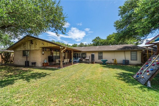 10637 Westwood Dr, Corpus Christi, TX 78410 - rear view of property with a patio and a yard