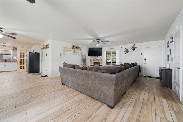 10637 Westwood Dr, Corpus Christi, TX 78410 - living room with a ceiling fan, a fireplace, and light wood finished floors
