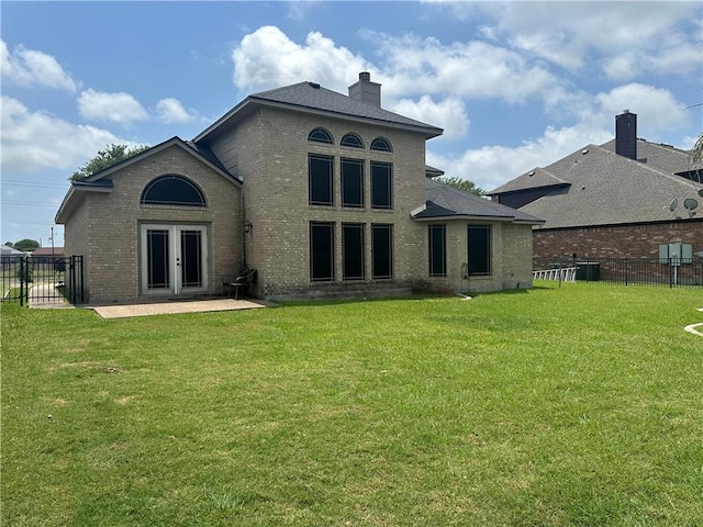 6333 Oso Pkwy, Corpus Christi, TX 78414 - rear view of house featuring brick siding, a chimney, cooling unit, and a patio