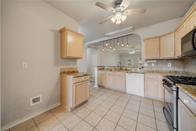 kitchen with gas stove, ceiling fan, white dishwasher, and light tile patterned flooring