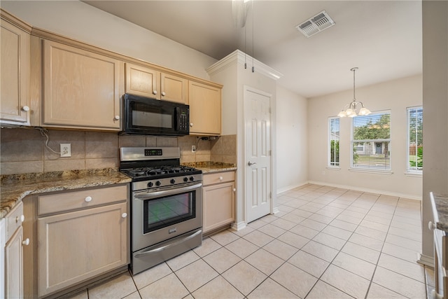 kitchen featuring an inviting chandelier, tasteful backsplash, light stone countertops, and gas range