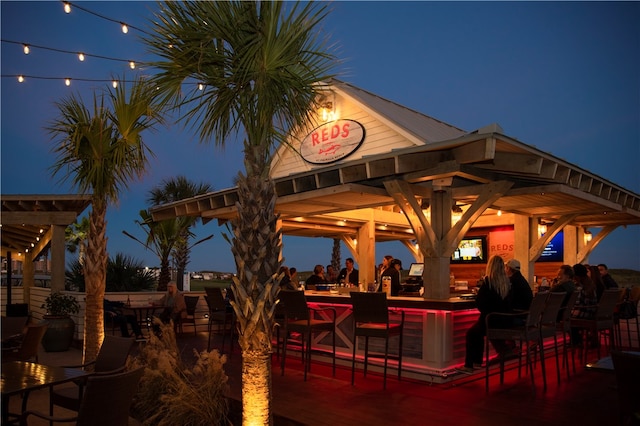 patio at twilight featuring an outdoor bar