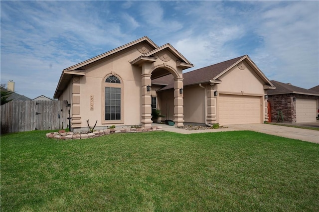 view of front of home with an attached garage, fence, driveway, stucco siding, and a front yard