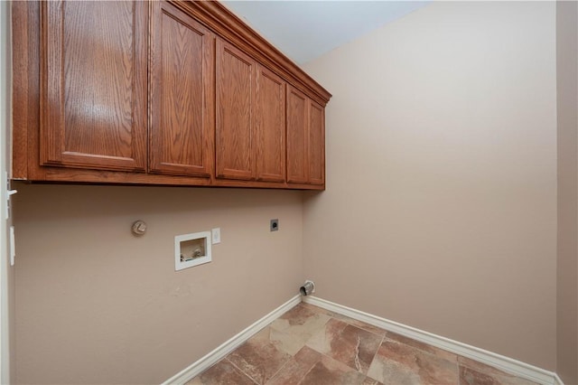 clothes washing area featuring washer hookup, hookup for a gas dryer, cabinet space, hookup for an electric dryer, and baseboards