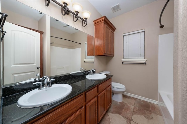 bathroom with toilet, a sink, visible vents, and baseboards