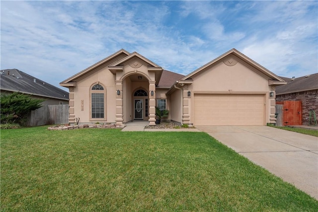 view of front of home featuring a garage, fence, concrete driveway, stucco siding, and a front yard