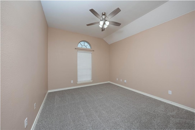 carpeted spare room featuring vaulted ceiling, ceiling fan, and baseboards