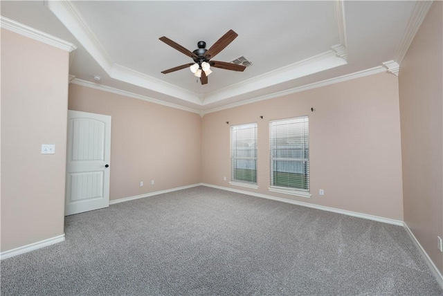 unfurnished room featuring carpet floors, baseboards, visible vents, and a raised ceiling