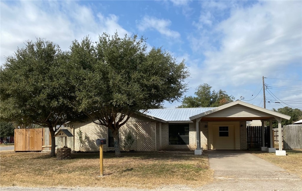 ranch-style house featuring a carport