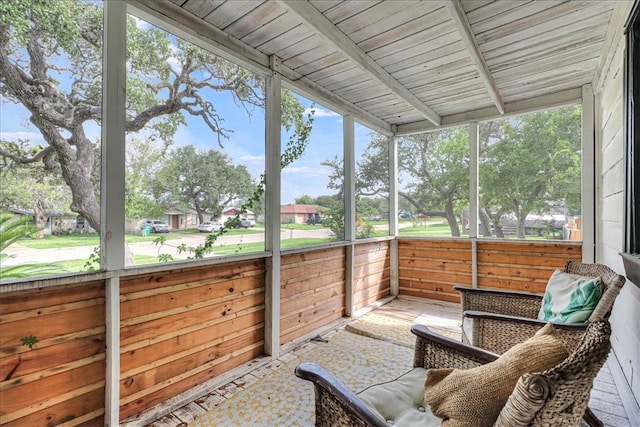 sunroom featuring beam ceiling and wooden ceiling