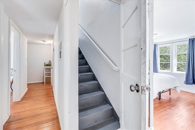 stairs featuring wood-type flooring