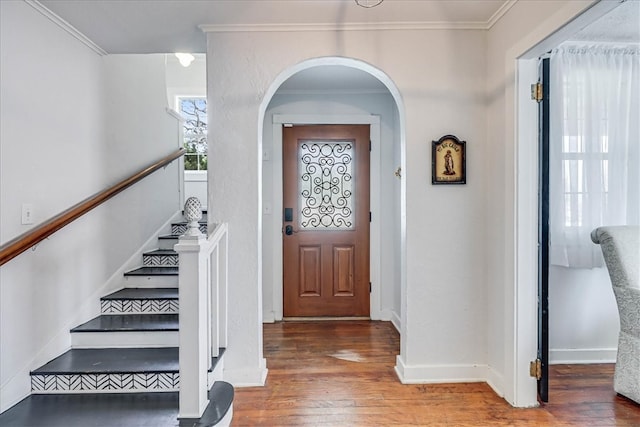 entrance foyer featuring hardwood / wood-style floors and crown molding