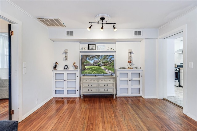 unfurnished living room featuring dark hardwood / wood-style flooring and crown molding