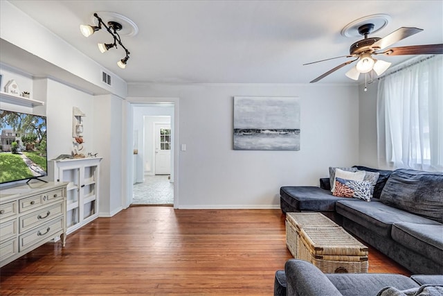 living room featuring hardwood / wood-style floors and ceiling fan