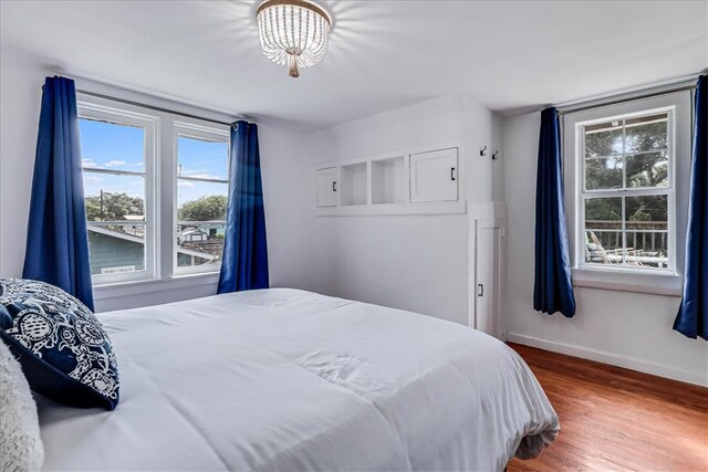 bedroom featuring hardwood / wood-style flooring and multiple windows