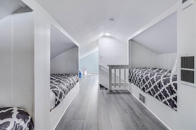 bedroom featuring lofted ceiling and hardwood / wood-style floors