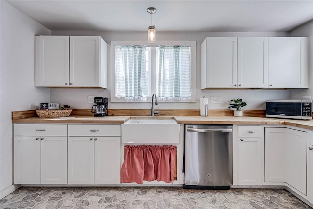 kitchen featuring white cabinets, appliances with stainless steel finishes, hanging light fixtures, and sink