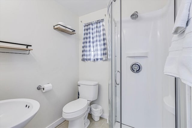 bathroom featuring walk in shower, tile patterned flooring, and toilet