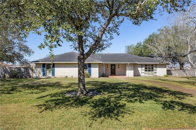 ranch-style home with fence, a front lawn, and brick siding