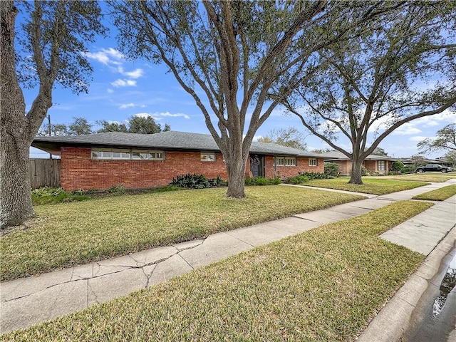 single story home featuring a front yard