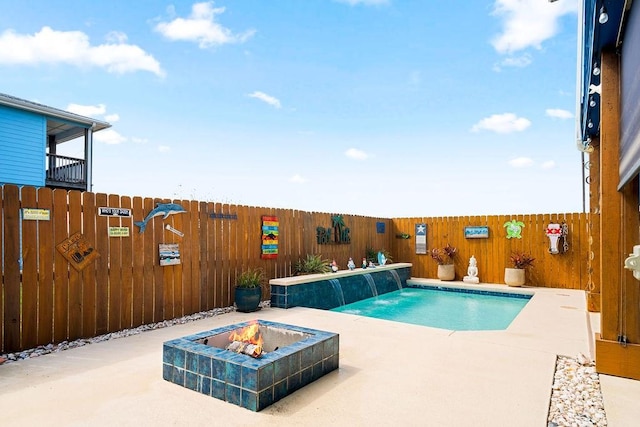 view of pool with a patio area, a fenced backyard, a fire pit, and a fenced in pool