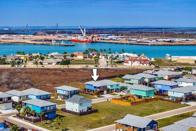 drone / aerial view with a water view and a residential view