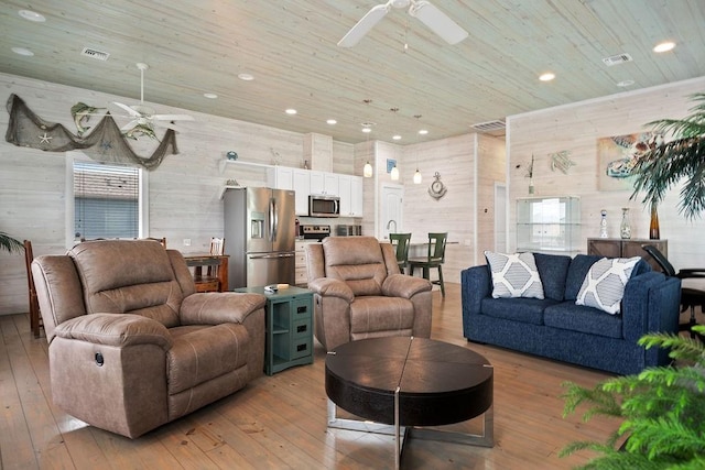 living room with wood ceiling, visible vents, ceiling fan, and hardwood / wood-style floors