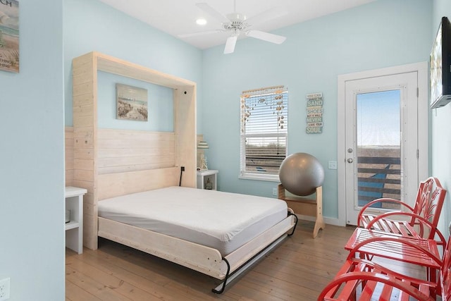 bedroom with hardwood / wood-style flooring, baseboards, and a ceiling fan