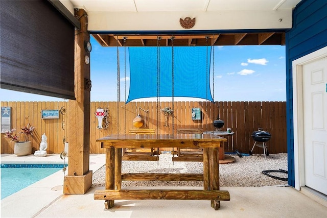 view of patio featuring fence and grilling area