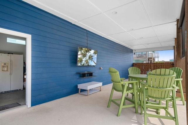 view of patio with outdoor dining space and fence