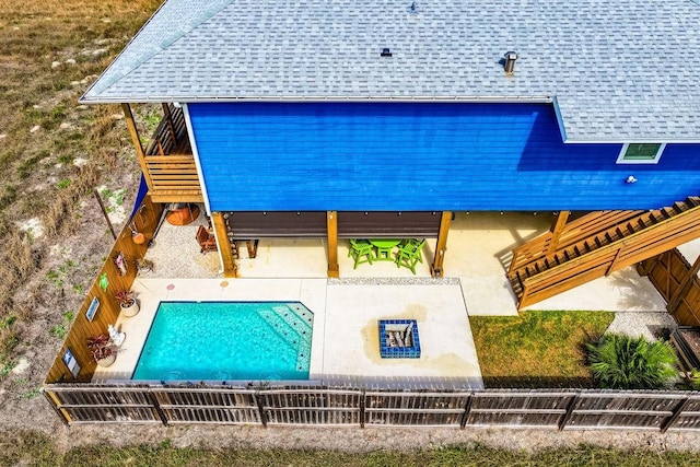 view of swimming pool featuring a patio area and fence