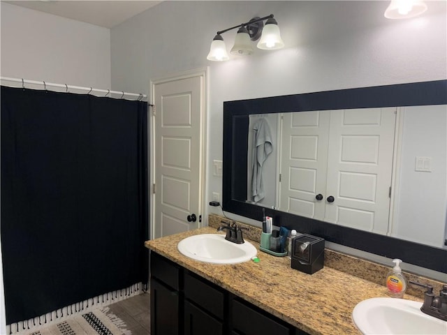 bathroom featuring hardwood / wood-style flooring and vanity