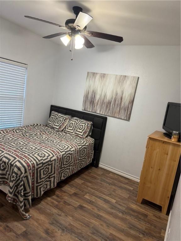 bedroom with ceiling fan and dark hardwood / wood-style flooring