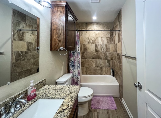 full bathroom featuring vanity, hardwood / wood-style flooring, toilet, and shower / tub combo