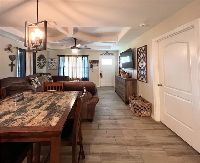 dining room with light hardwood / wood-style flooring and ceiling fan with notable chandelier