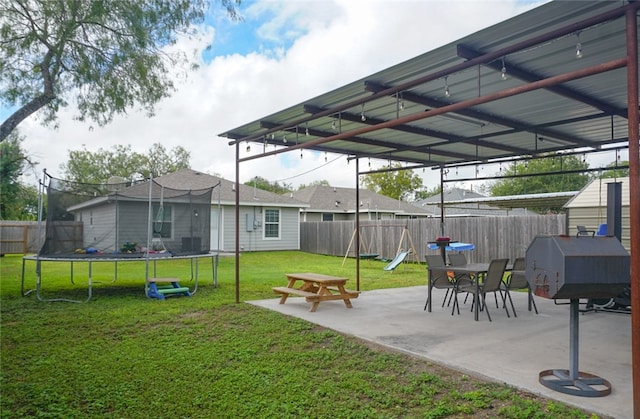 view of yard featuring a patio and a trampoline