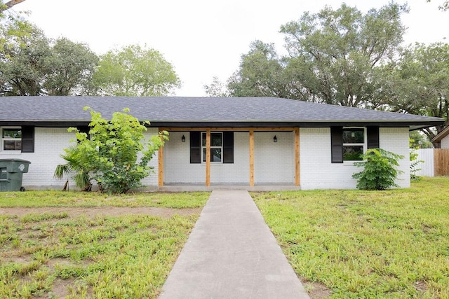 1101 Lillian St, Alice, TX 78332 - single story home featuring covered porch, brick siding, a front lawn, and roof with shingles