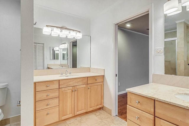 bathroom featuring toilet, vanity, and a shower with door