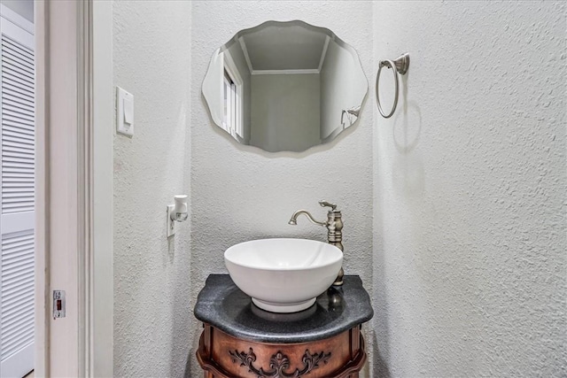 bathroom featuring vanity and crown molding