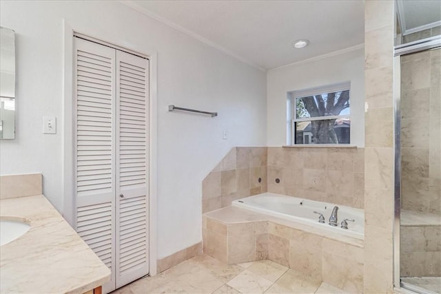 bathroom with vanity, ornamental molding, and shower with separate bathtub