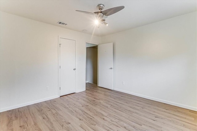 empty room featuring ceiling fan and light hardwood / wood-style floors