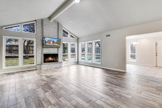 unfurnished living room featuring vaulted ceiling with beams and a fireplace